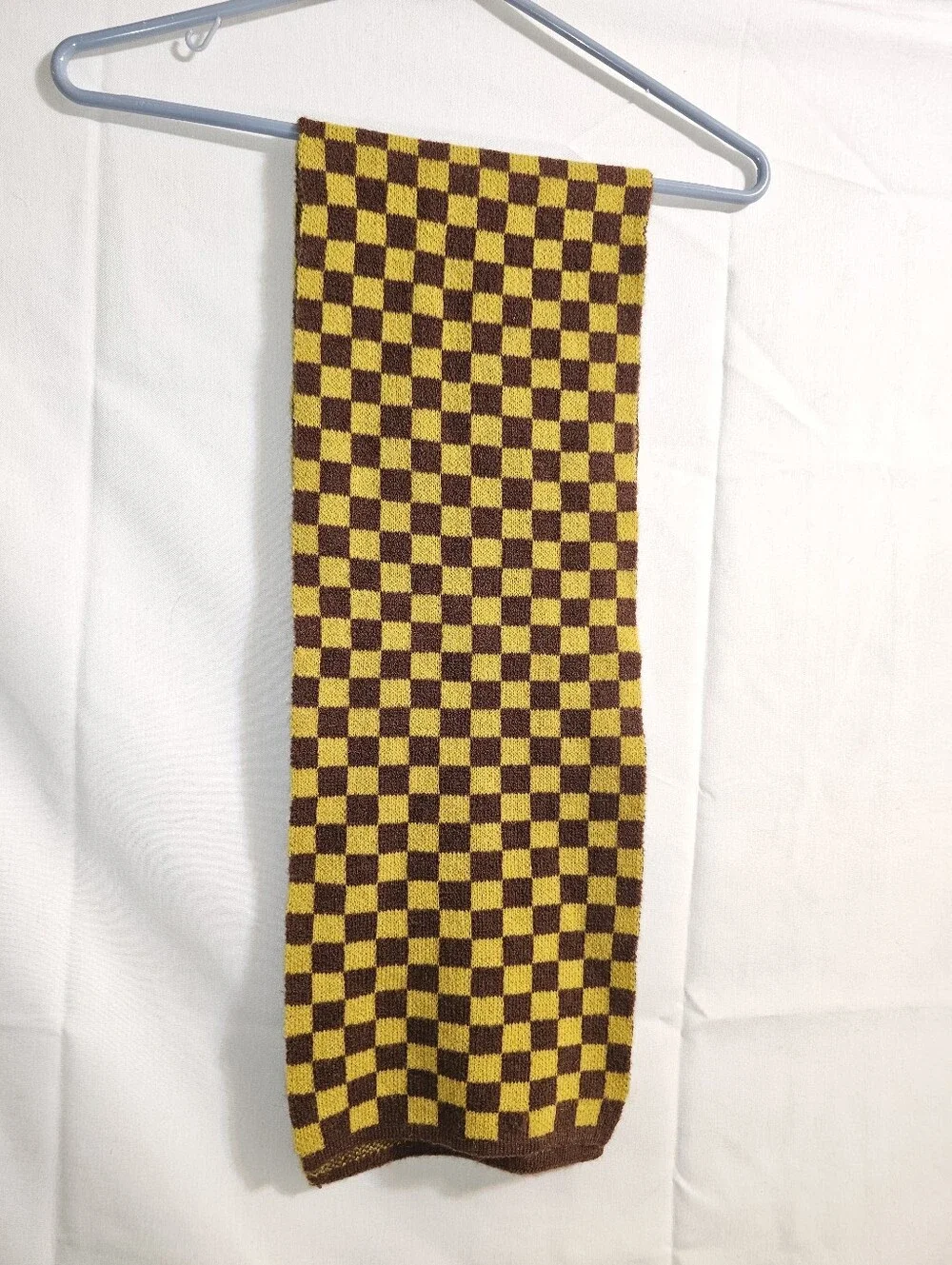 soft knit scarf  brown and mustard yellow checkerboard pattern.